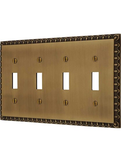 Ovolo Quad Gang Toggle Switch Plate in Antique Brass.